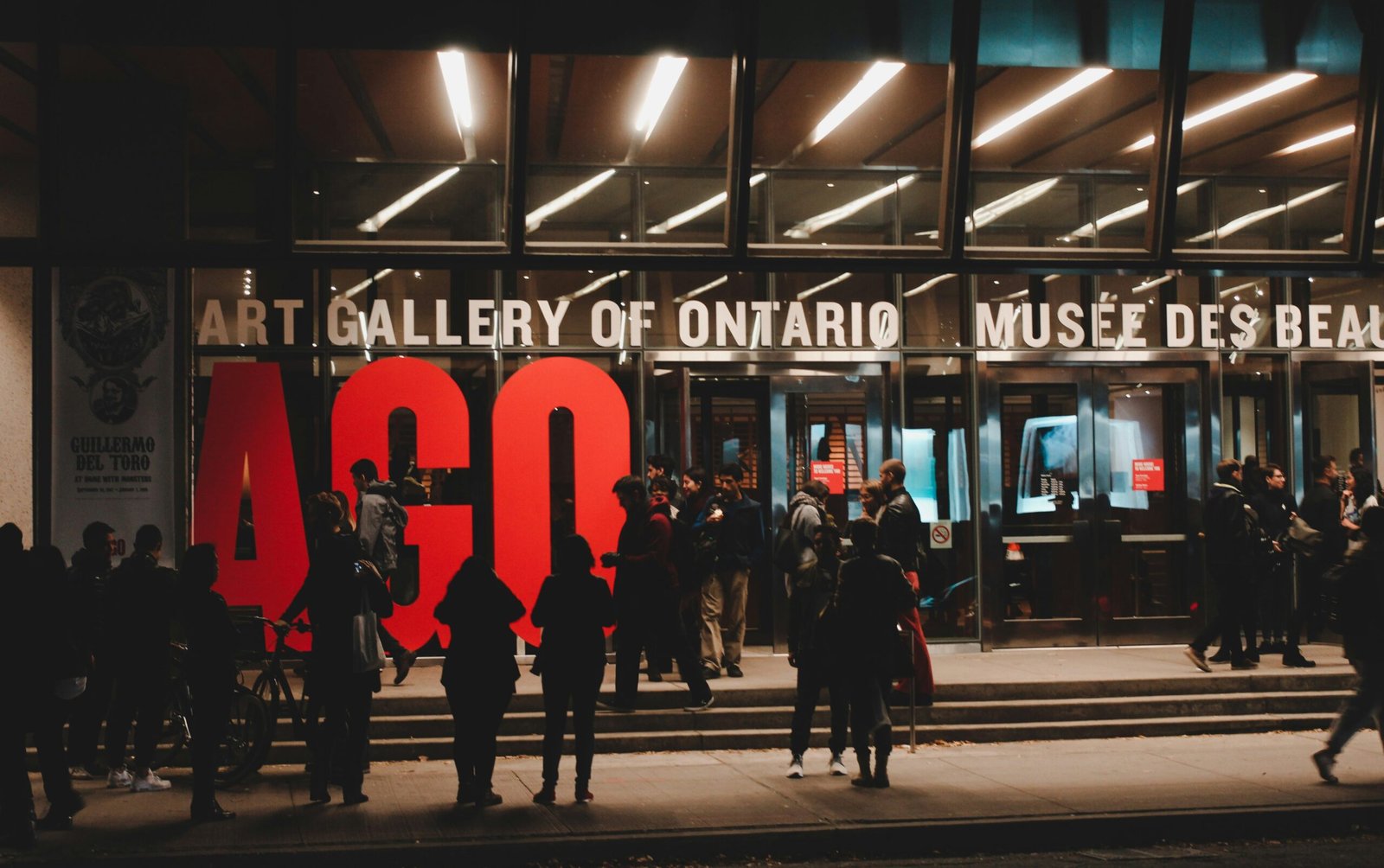 Visitors entering the Art Gallery of Ontario at night in downtown Toronto