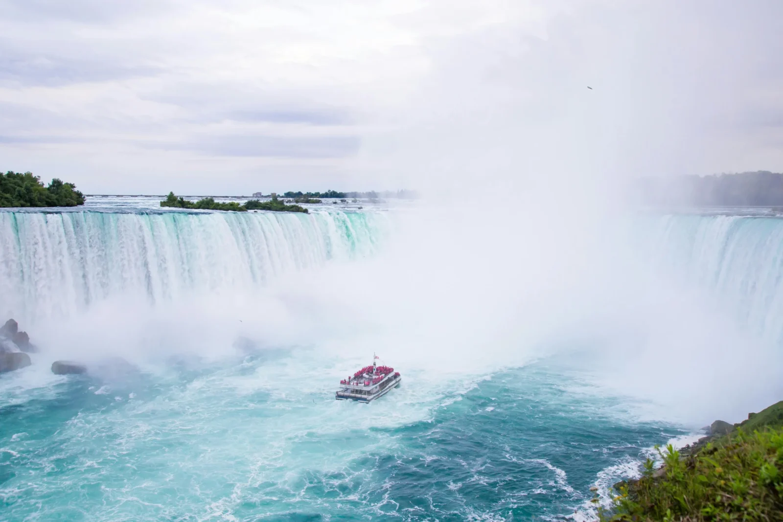 Niagara City Cruises boat approaching Horseshoe Falls in heavy mist