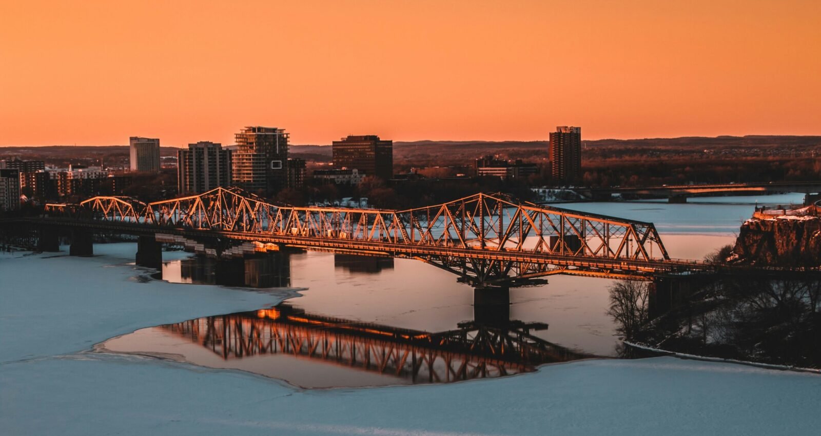 Sunset over the Ottawa River with bridge and skyline