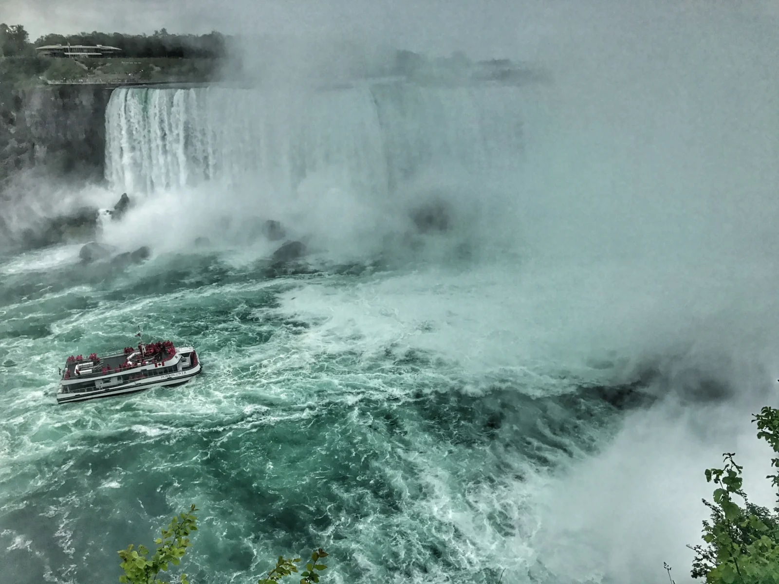 Niagara Falls boat tour approaching Horseshoe Falls in summer